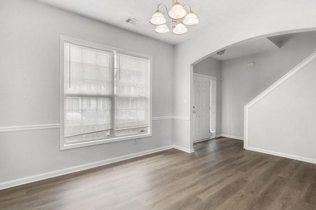 interior space with dark wood-type flooring and a notable chandelier