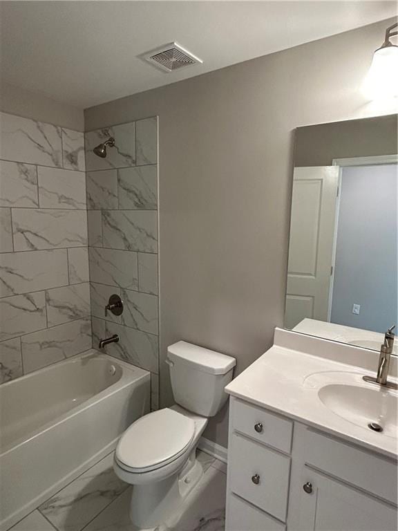 full bathroom featuring tiled shower / bath, vanity, and toilet