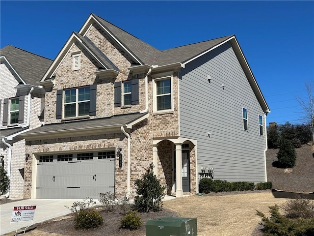 view of front facade with concrete driveway, brick siding, and an attached garage