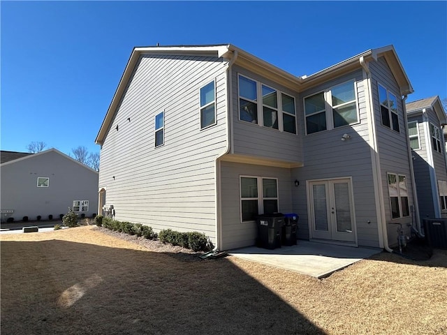 back of property with a patio, french doors, and cooling unit