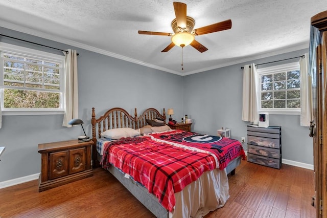 bedroom featuring baseboards, a ceiling fan, ornamental molding, wood finished floors, and a textured ceiling