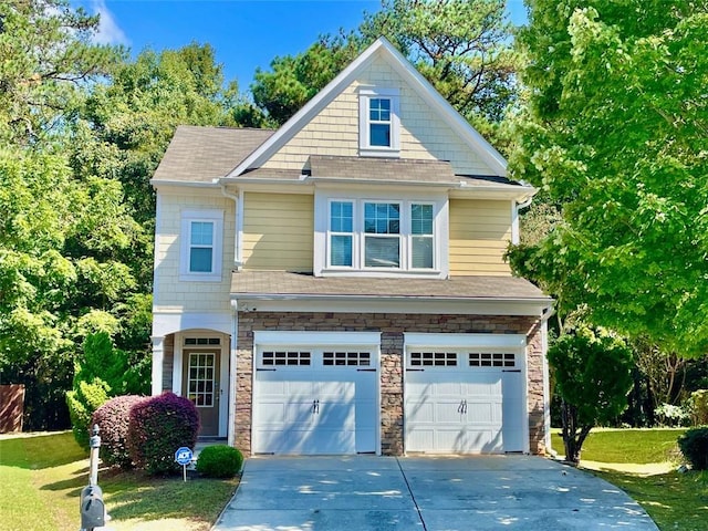 view of front of house with a front yard and a garage