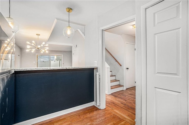 interior space with an inviting chandelier and hardwood / wood-style flooring