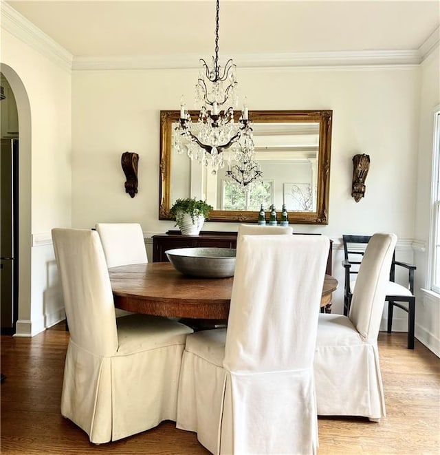 8525 Anchor On Lanier Ct, Gainesville, GA 30506 - dining room featuring arched walkways, an inviting chandelier, crown molding, and wood finished floors