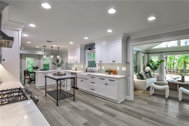 270 Hollyridge Way, Roswell, GA 30076 - kitchen with ornamental molding, a peninsula, healthy amount of natural light, white cabinets, and tasteful backsplash