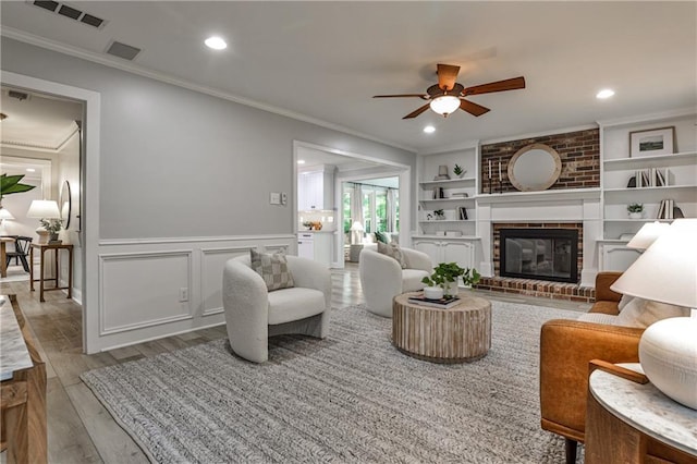 270 Hollyridge Way, Roswell, GA 30076 - living area featuring a ceiling fan, wood finished floors, ornamental molding, a fireplace, and recessed lighting