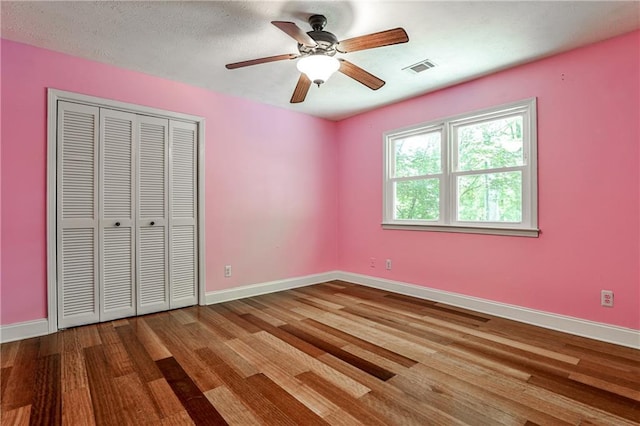 270 Hollyridge Way, Roswell, GA 30076 - unfurnished bedroom featuring wood finished floors, a closet, and a ceiling fan