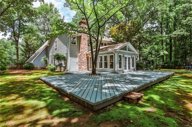 270 Hollyridge Way, Roswell, GA 30076 - rear view of house featuring a trampoline, a wooden deck, a chimney, and french doors