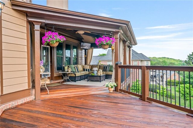 wooden deck featuring a ceiling fan