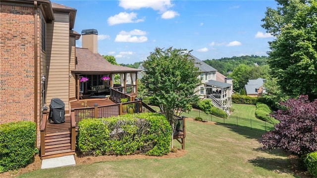 view of yard with fence and a wooden deck