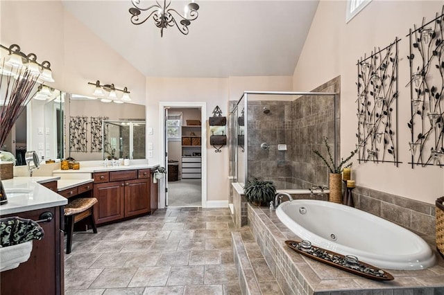 full bath with a bath, a stall shower, vanity, baseboards, and a notable chandelier