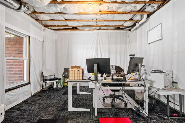 office featuring baseboards, carpet, ceiling fan, and lofted ceiling