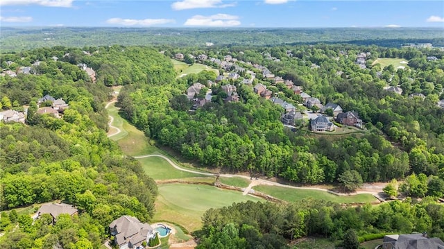bird's eye view featuring a view of trees, golf course view, and a residential view