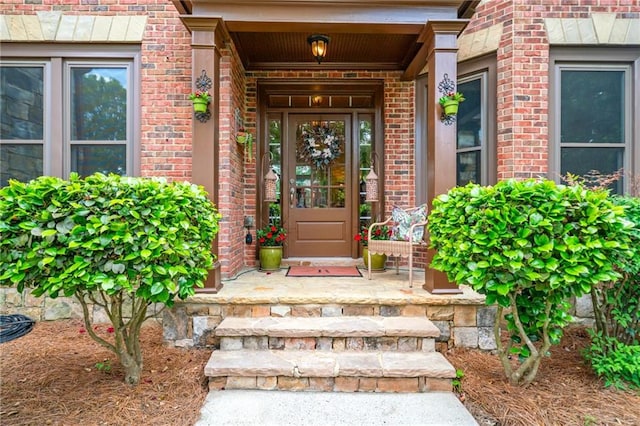 view of exterior entry with brick siding