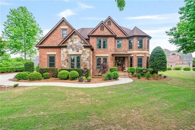 craftsman-style home with brick siding and a front lawn