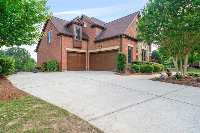 traditional-style house with an attached garage, driveway, and brick siding