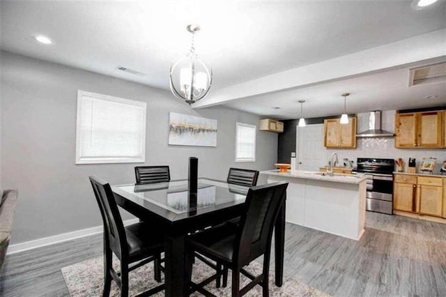 dining room featuring sink and hardwood / wood-style flooring