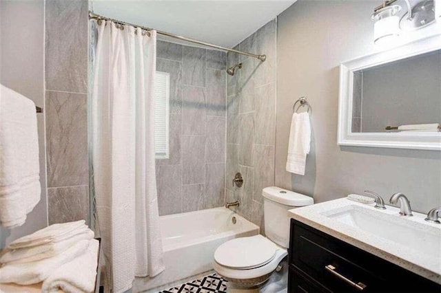 full bathroom featuring shower / bath combo, toilet, and vanity