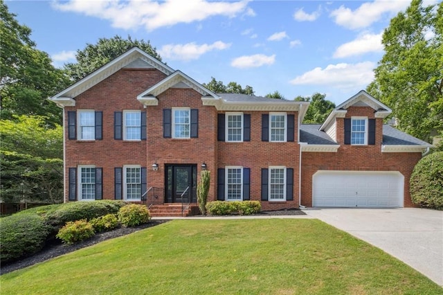2350 Twelvestones Dr, Roswell, GA 30076 - colonial-style house with concrete driveway, a front yard, brick siding, and a garage