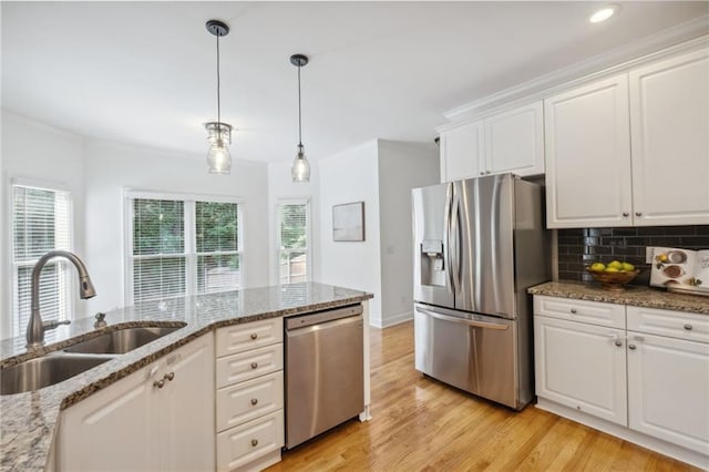 2350 Twelvestones Dr, Roswell, GA 30076 - kitchen featuring stainless steel appliances, a sink, ornamental molding, white cabinetry, and light wood-type flooring