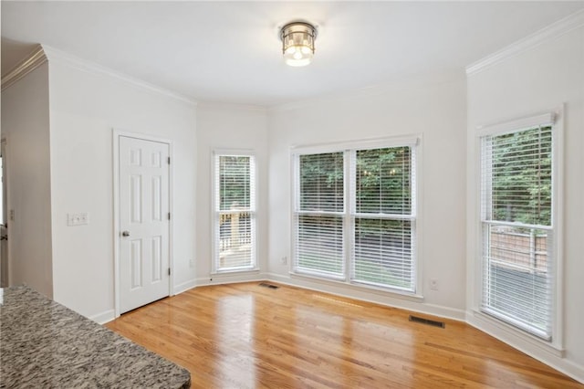 2350 Twelvestones Dr, Roswell, GA 30076 - unfurnished dining area featuring light wood-type flooring, crown molding, and baseboards