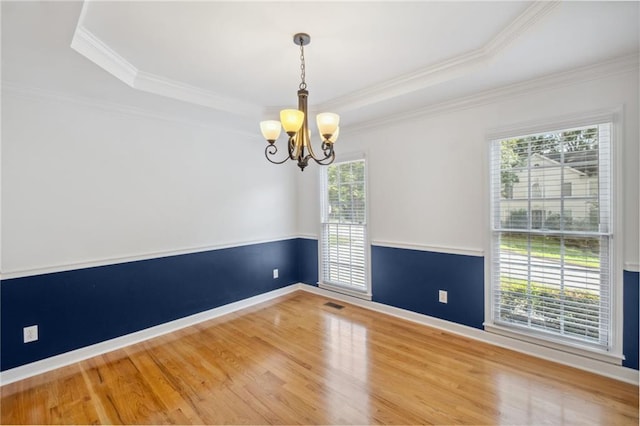 2350 Twelvestones Dr, Roswell, GA 30076 - spare room featuring plenty of natural light, a chandelier, wood finished floors, a tray ceiling, and crown molding