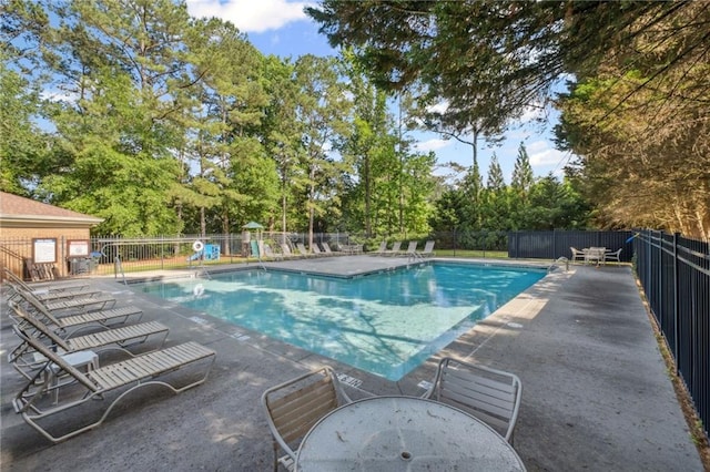 2350 Twelvestones Dr, Roswell, GA 30076 - community pool featuring a patio area and view of wooded area