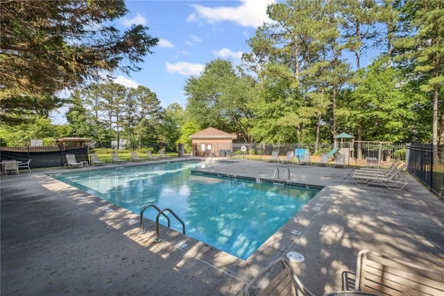 2350 Twelvestones Dr, Roswell, GA 30076 - community pool featuring a patio area and view of scattered trees