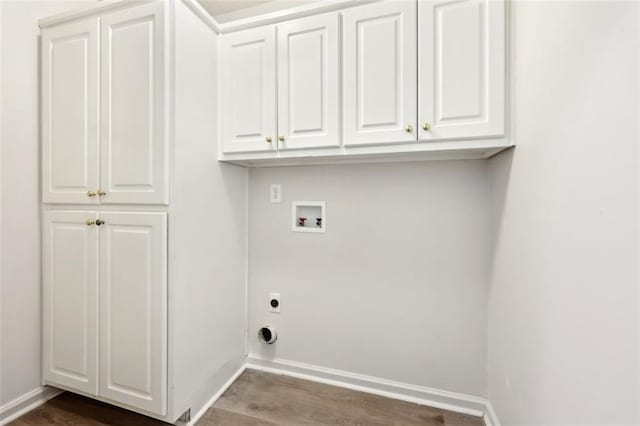 clothes washing area featuring cabinet space, baseboards, wood finished floors, hookup for a washing machine, and electric dryer hookup