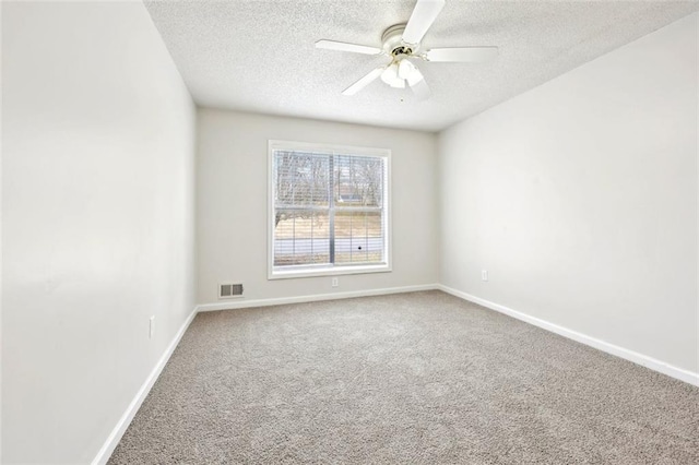 empty room with a ceiling fan, baseboards, visible vents, and carpet flooring