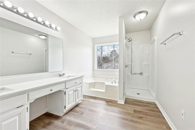 full bathroom featuring a garden tub, a shower, double vanity, and wood finished floors