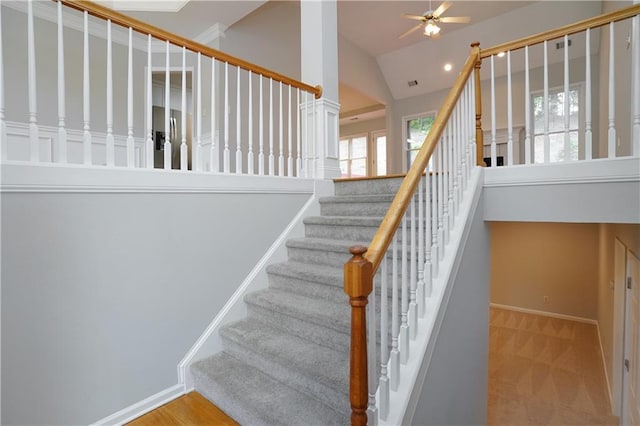 655 Golden Meadows Ln, Suwanee, GA 30024 - staircase featuring plenty of natural light, a ceiling fan, high vaulted ceiling, and carpet floors