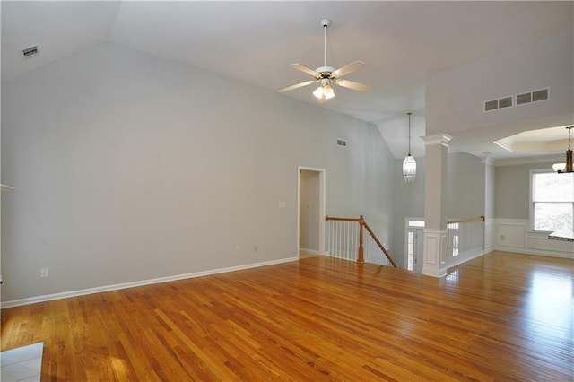 655 Golden Meadows Ln, Suwanee, GA 30024 - unfurnished room featuring wood finished floors, a ceiling fan, ornate columns, a chandelier, and high vaulted ceiling