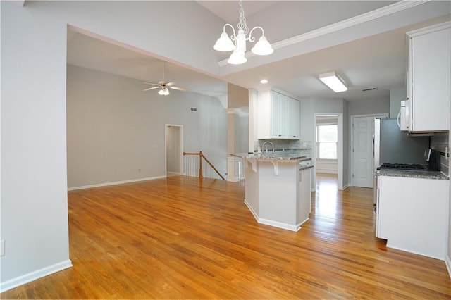 655 Golden Meadows Ln, Suwanee, GA 30024 - kitchen featuring tasteful backsplash, white cabinets, a kitchen bar, ceiling fan, and light wood-style floors