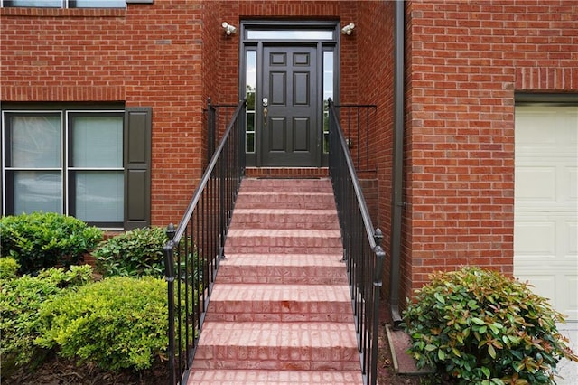 655 Golden Meadows Ln, Suwanee, GA 30024 - view of exterior entry with brick siding and a garage