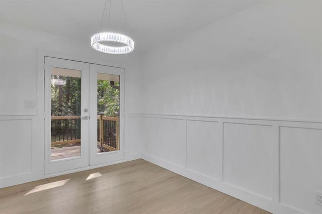 unfurnished dining area featuring light hardwood / wood-style floors and french doors