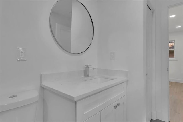 bathroom with toilet and vanity