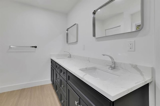 bathroom with hardwood / wood-style flooring and vanity