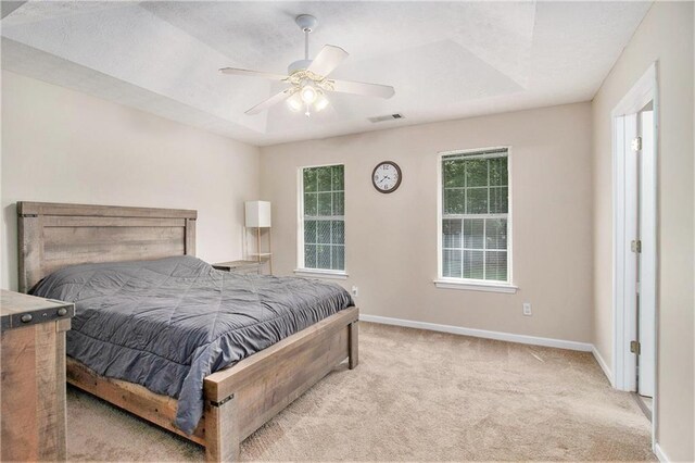 60 Cypress Dr, Covington, GA 30016 - carpeted bedroom with ceiling fan and a raised ceiling