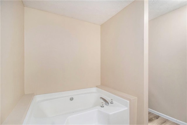60 Cypress Dr, Covington, GA 30016 - full bath featuring a garden tub and a textured ceiling