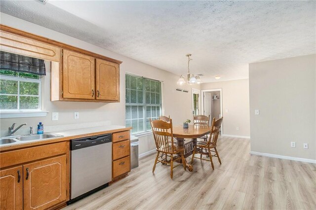60 Cypress Dr, Covington, GA 30016 - kitchen featuring stainless steel dishwasher, a chandelier, light wood finished floors, a textured ceiling, and light countertops