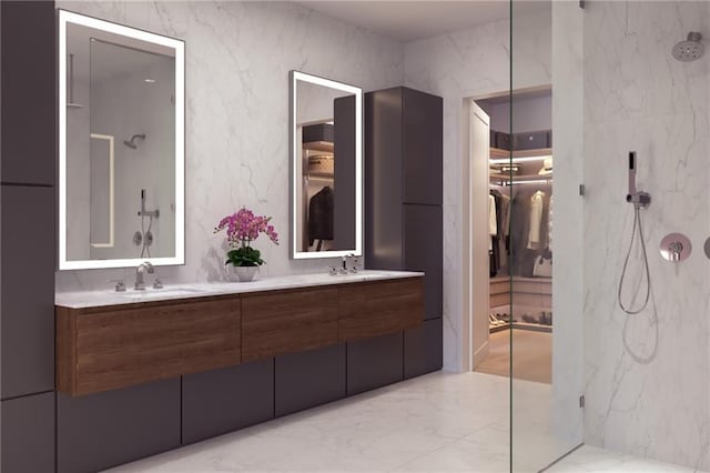 bathroom featuring marble finish floor, a sink, a spacious closet, and a marble finish shower