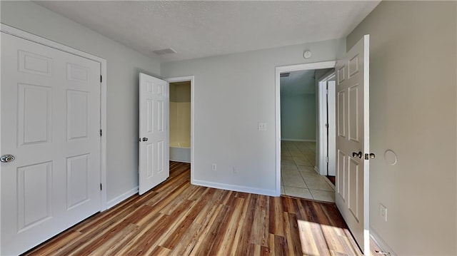 145 Charleston Pl, Covington, GA 30016 - unfurnished bedroom with wood finished floors and baseboards