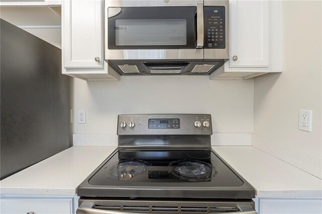 kitchen featuring light countertops, appliances with stainless steel finishes, and white cabinetry