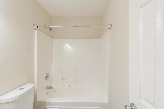 bathroom with toilet and bathtub / shower combination