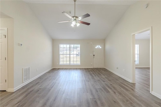 interior space with visible vents, ceiling fan, baseboards, and wood finished floors