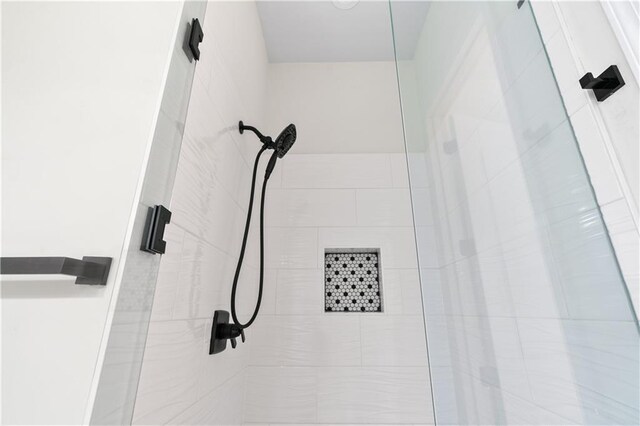 bathroom featuring tile patterned floors, vanity, an enclosed shower, and toilet