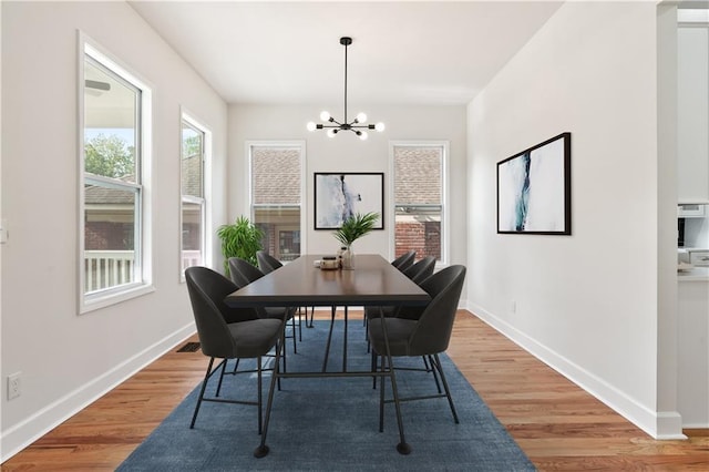 dining area with a chandelier and hardwood / wood-style flooring