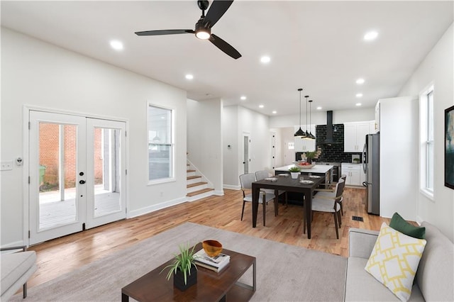 living room featuring french doors, light hardwood / wood-style flooring, and ceiling fan