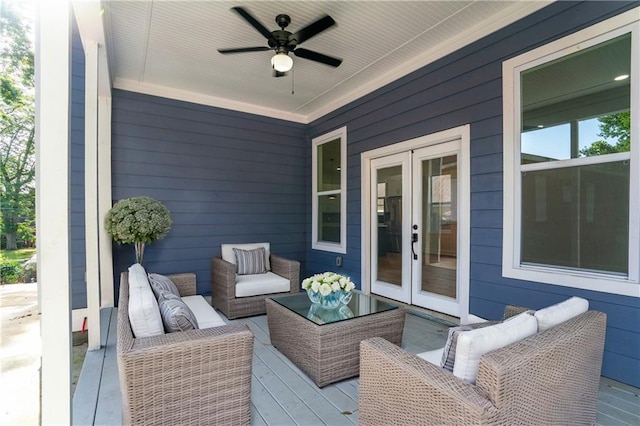 wooden terrace with outdoor lounge area, ceiling fan, and french doors